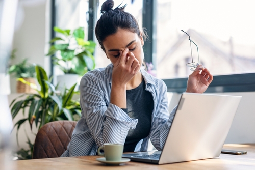 Frustrated woman at her laptop